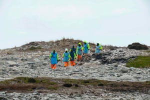 Zimbabweans work on a mined beach in Stanley