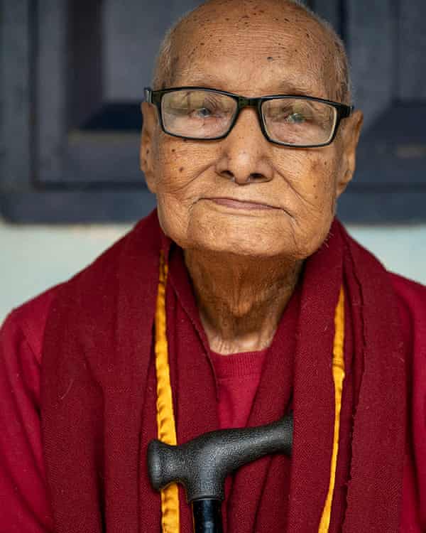 An old man in maroon robes