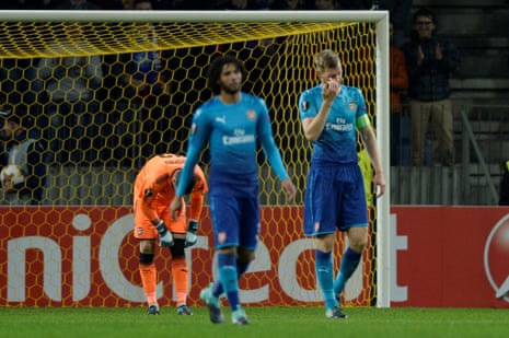 Arsenal’s Per Mertesacker, rigth, looks dejected after Borisov’s Mikhail Gordeichuk scored their second goal.