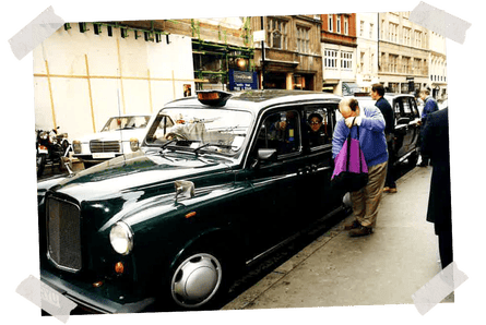 Dad opening his tote bag next to a London taxi, late 1990s.