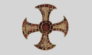 As well as the cross, gold and garnet pins, an iron knife, glass beads and a chain were also found in the grave.