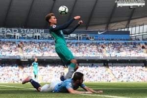 Dele Alli of Tottenham Hotspur controls the ball after battling for possession with Bernardo Silva of Manchester City.