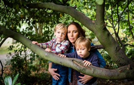 Stella Moris, partner of Julian Assange, with her two sons, in front of a tree. Autumn 2021