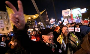 A demonstrator shows a victory sign as he takes part in a march in Warsaw against the rightwing Polish government.