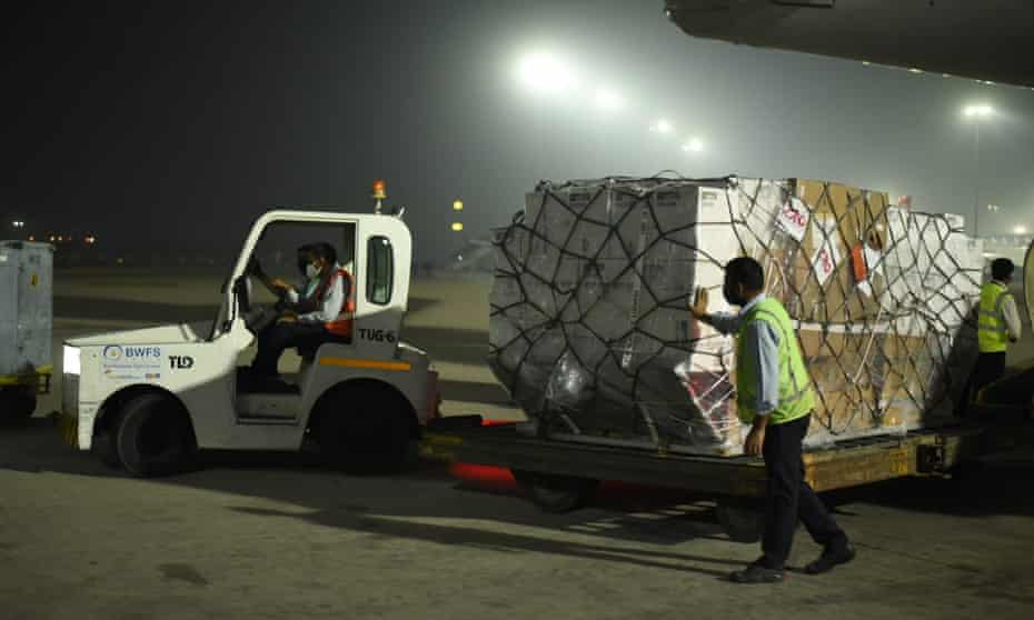 Baggage vehicle putting trailer at airport in dark