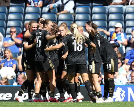 Eight Aston Villa players embrace to celebrate their equaliser at Chelsea