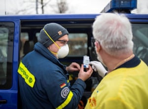 A member of the THW (Technisches Hilfswerk) and member of the ASB (Arbeiter-Samariter-Bund) check the temperature of a box with Pfizer-BioNTech COovid-19 vaccines at a vaccination centre in Bad Windsheim, Germany on December 26, 2020, one day before the country starts its vaccination programme.