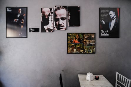 view inside a cafe with The Godfather film posters on a pale grey wall