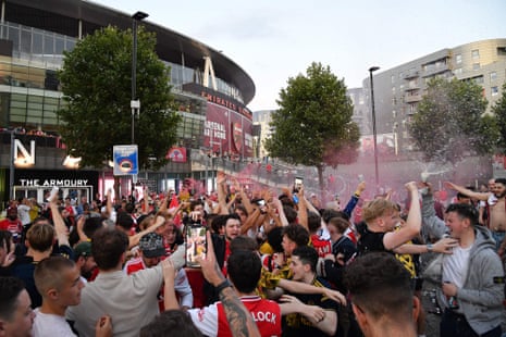 Arsenal fans celebrate outside the Emirates stadium.