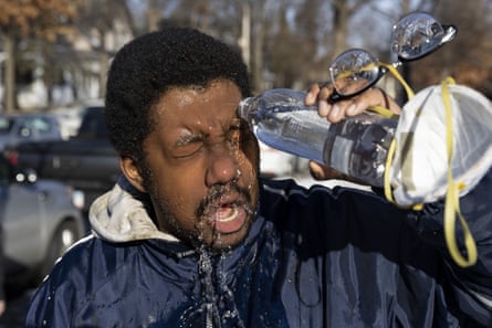 a man pours water on his eyes