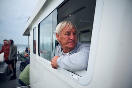 Andrew Douglas looks out of the window of a boat