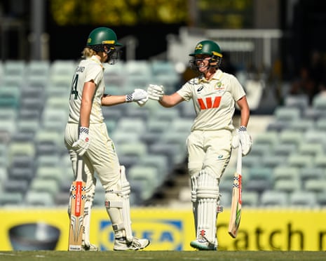 Annabel Sutherland and Beth Mooney fist bump during day two of the women’s Test