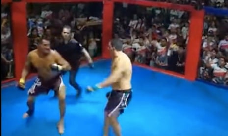 Simão Peixoto and Erineu da Silva fight it out in front of hundreds of paying spectators in the gymnasium of a local school in Borba.