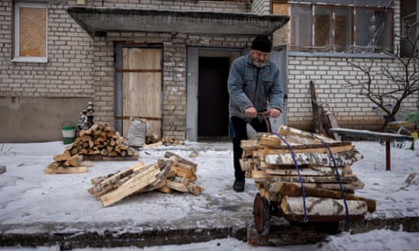 Hennadiy Batsak, 63, gathers wood he uses to heat his apartment that lacks heating, water and gas in Lyman