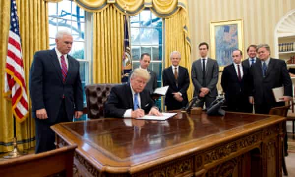 Donald Trump, watched by Mike Pence, among others, signs the ‘global gag rule’ in 2017.