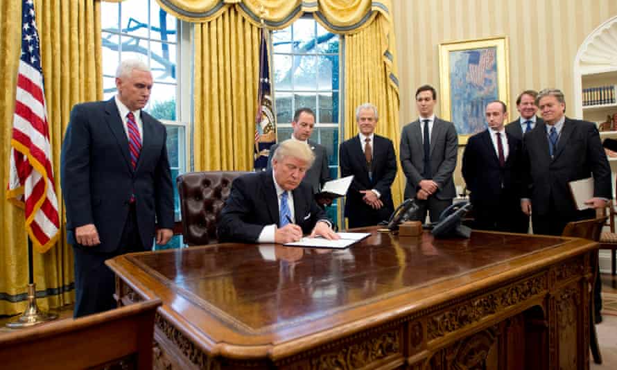Donald Trump signs the global ‘gag rule’, surrounded by men.