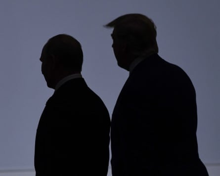 Vladimir Putin and Donald Trump in silhouette standing next to each other