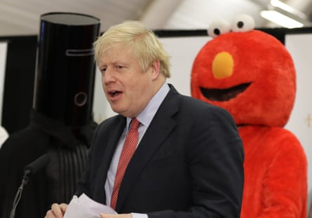 Lord Buckethead and someone dressed as Elmo on stage with Boris Johnson