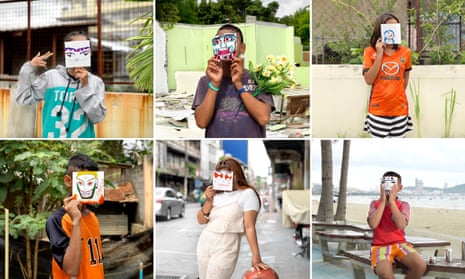 Children from two shelters in Thailand, all of them victims of commercial sexual exploitation, hold up the masks they have drawn to depict how they would like to be seen, as part of an awareness project to convey their plight.