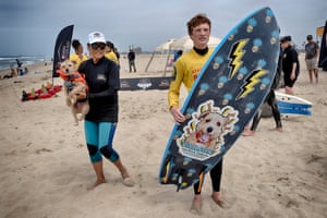 Carson poses with his coach Jill Nakano, left, and his surfboard.