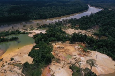 An aerial photo of a treeless area of sand dotted with pools of discoloured water