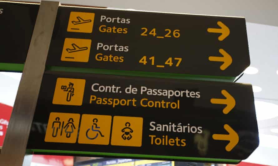 Gates, passport control and toilets signs are seen at Lisbon’s airport, Portugal.