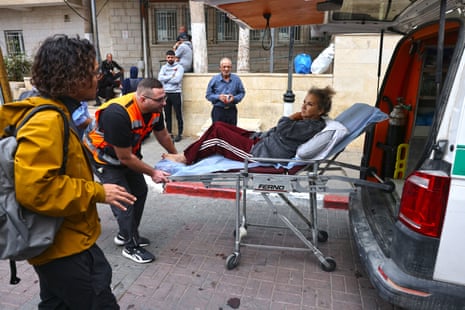 American freelance photojournalist Heidi Levine is transferred on a stretcher into a Palestinian ambulance from the government hospital in the Israeli-occupied city of Ramallah.