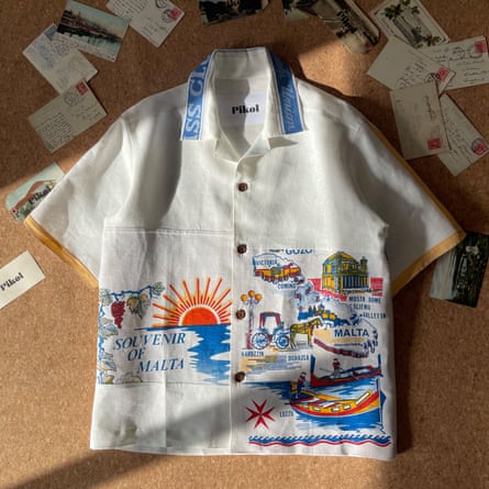 A white short-sleeved button-through shirt made partly of coloured souvenir fabrics of Malta