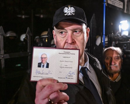 Bogdan Swieczkowski, Constitutional Tribunal president, holds up his judicial identification card