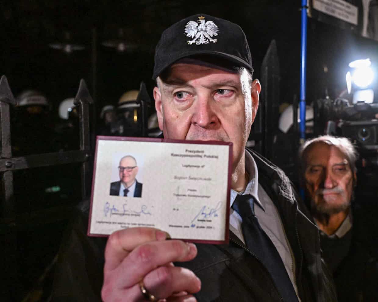 Bogdan Swieczkowski, Constitutional Tribunal president, holds up his judicial identification card