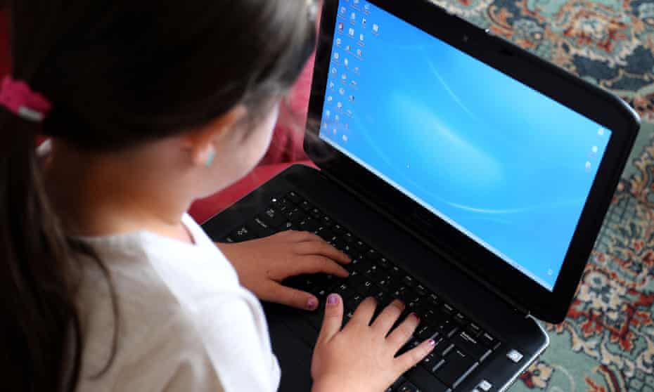 A child using a laptop computer.