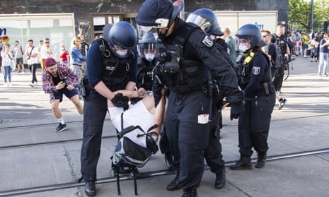 German police detain a protester demonstrating against lockdown measures on Alexanderplatz in Berlin