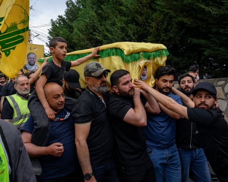 Members and supporters of Iran-backed Hezbollah mourn and bury four fighters and two civilians – killed by Israel during recent fighting – in Maaroub, southern Lebanon
