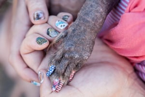 Heather Wilson, owner of ugly dog contestant Himisaboo, shows of their decorated nails