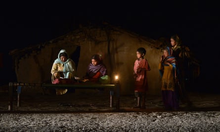 A girl studies by candlelight in an area without electric power in Phillaur, India
