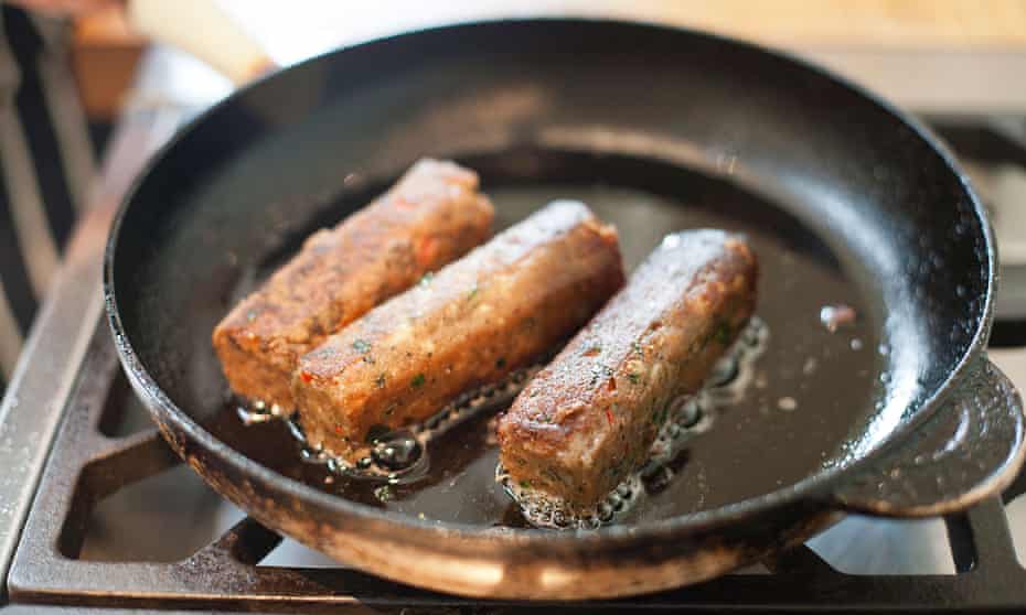 Vegetarian sausages being fried