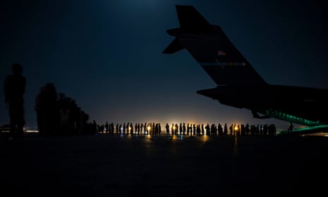 People queue to board a US military aircraft at Kabul airport