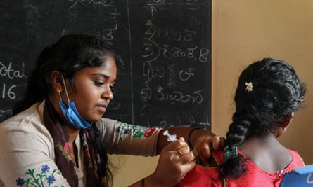 A health worker inoculates a student with a Covid vaccine at a school in Bangalore.