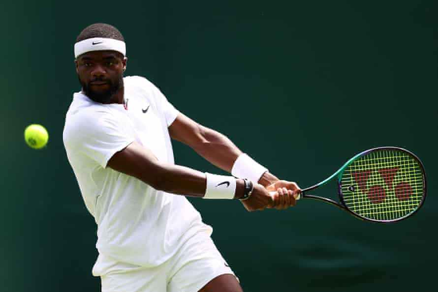 Frances Tiafoe hits a shot.