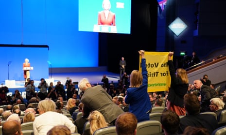 Liz Truss Delivers Her Leader's Speech To Party Conservative Party Conference<br>BIRMINGHAM, ENGLAND - OCTOBER 05: A protester interrupts Prime Minister Liz Truss's keynote speech on the final day of the Conservative Party Conference on October 5, 2022 in Birmingham, England. This year the Conservative Party Conference will be looking at "Getting Britain Moving" with more jobs and higher salaries.  (Photo by Ian Forsyth/Getty Images)
