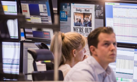 24 June, 2016: shocked traders on the Frankfurt stock exchange the day after the EU referendum, with the Daily Mail front page on a screen behind