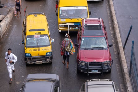 Street hawkers sell their goods amid Lagos traffic jams