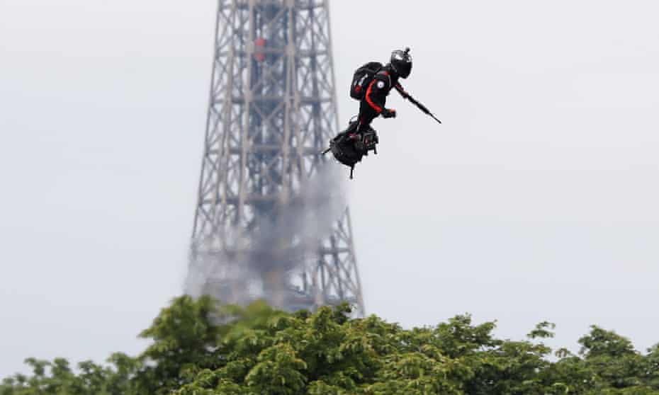 Franky Zapata soars on his Flyboard near the Champs-Élysées Avenue in Paris on Bastille Day, with the Eiffel Tower in the background,