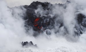 Lava flows into the ocean near Pahoa, Hawaii. Lava haze is formed when hot lava boils seawater, creating tiny shards of volcanic glass and hydrochloric acid. 