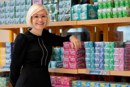 woman stands next to boxes of gum