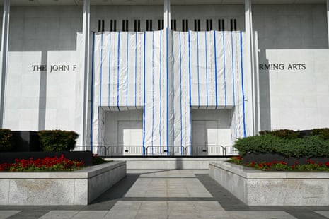 The Kennedy Center's entrance is wrapped in white plastic sheeting with blue tape stripes