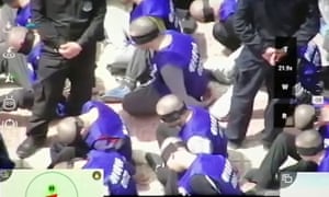 Headshaven, bound and blindfolded inmates, likely Uighurs, being transferred from a train in south-east Xinjiang. Photograph: War on Fear