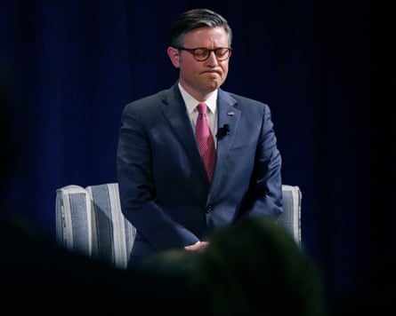 a man bows his head in prayer during an event
