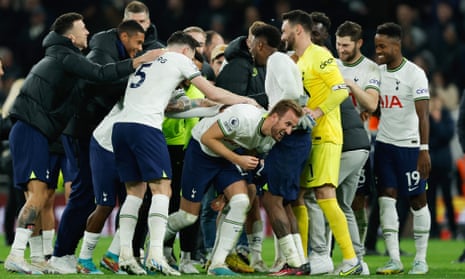 Harry Kane is mobbed by his Tottenham teammates at full time