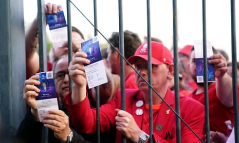 Liverpool fans stuck outside the ground show their match tickets before the Champions League final at the Stade de France in May.